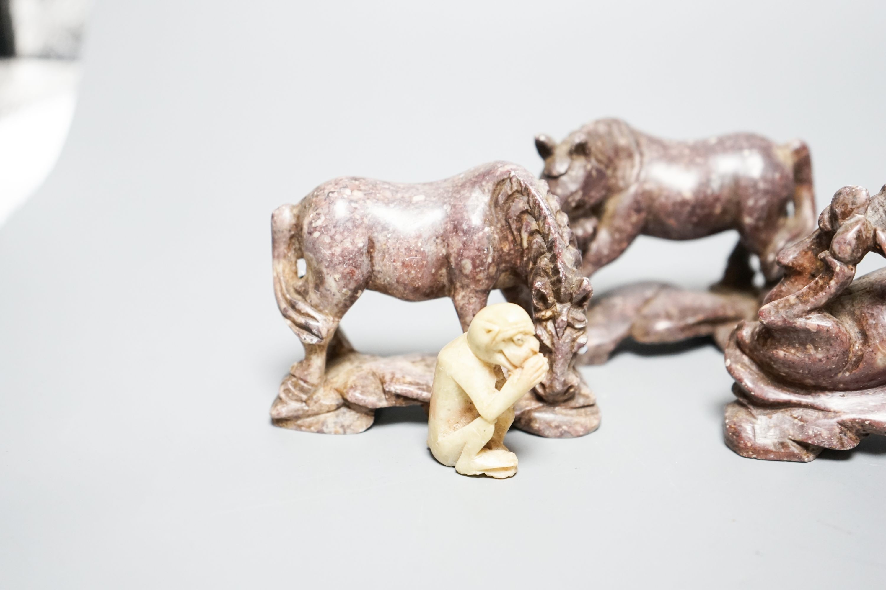 Six Chinese soapstone models of horses and a similar monkey, early 20th century